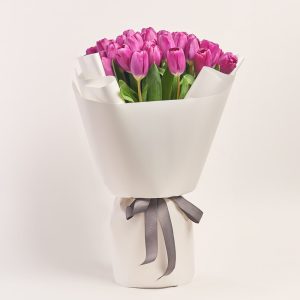 Magical rainbow: bouquet of purple tulips